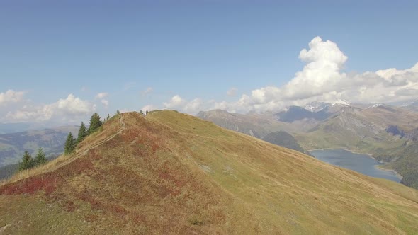 Aerial drone view of an empty hiking biking trail on a mountain hill.