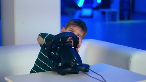 Concentrated Little Boy Playing Virtual Reality Racing Game