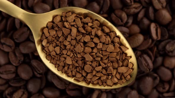 coffee. instant coffee in golden spoon and coffee beans on background rotation