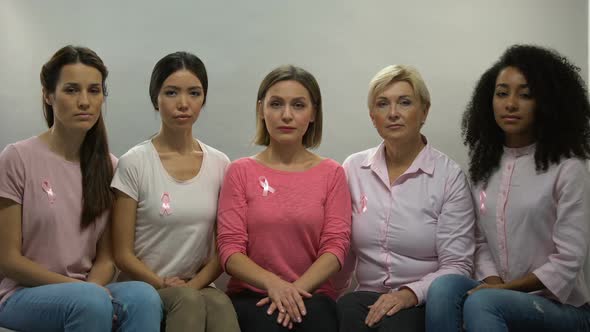 Ladies With Pink Ribbons Looking in Camera, Moral Support Breast Cancer Patients