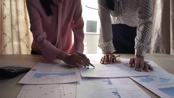 Two Female Business Partners Discussing Charts