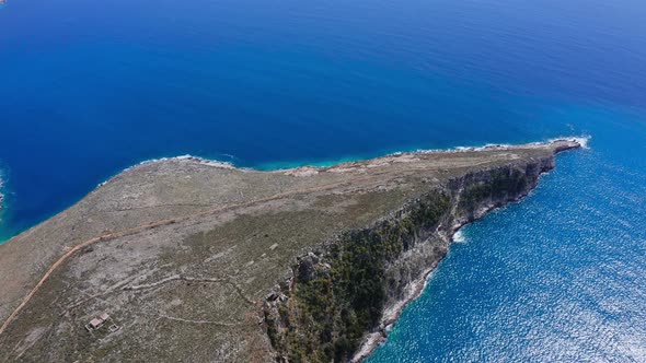 Aerial view of huge cliff extending into the sea and increasing the shoreline.
