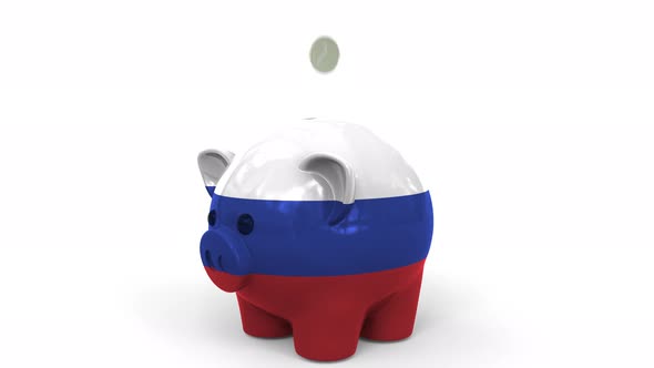 Coins Fall Into Piggy Bank Painted with Flag of Russia