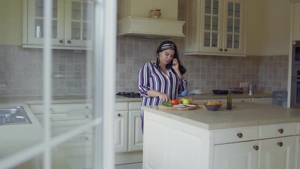 Plump Girl Is Cooking in the Kitchen