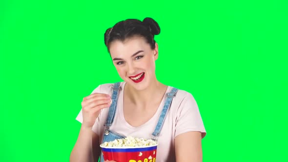 Girl Chews Popcorn While Watching a Movie. Girl Watching with Spellbound and Laughing, Slow Motion