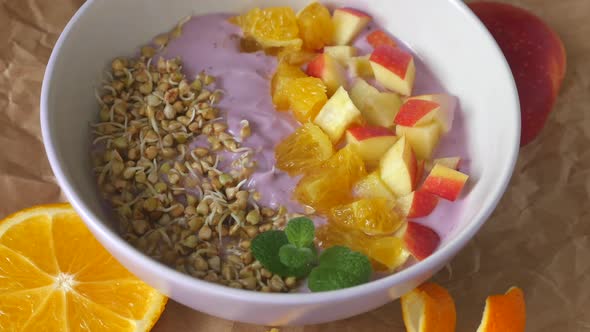 Rotating Healthy Breakfast with Fruits, Buckwheat and Berry Yogurt 