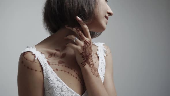 Portrait of a Young Woman Who Demonstrates Henna Painting on Her Body