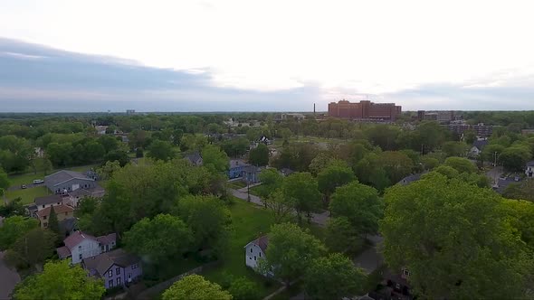 The houses of Flint, Michigan are captured from above bay drone at dusk.