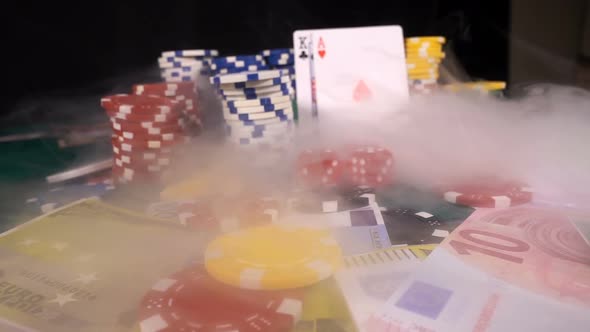 Gambling Red Dices Poker Cards And Money Chips In Smoke