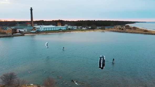 Aerial Drone View of a Corekites Kitesurfers Hydrofoiling  in Engure Port at in Baltic Sea