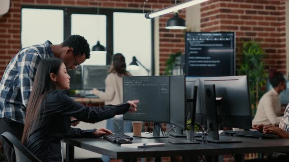 Mixed Team of Software Developers Analyzing Source Code Pointing at Screens Comparing Algorithm