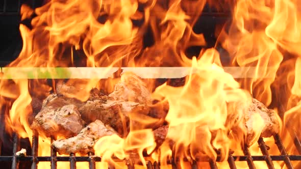 Closeup Cooking Meat on Barbecue Grilll Slow Motion Burning Fire Flame Smoke