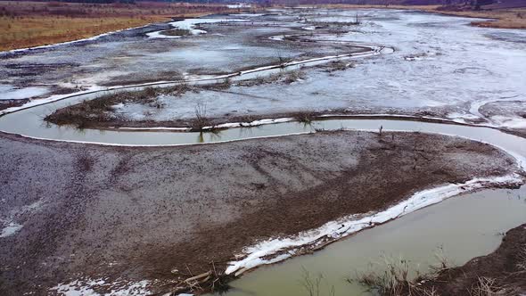 Muddy river. Dirty environment. Tortuous river in drought place. Polluted nature background. 