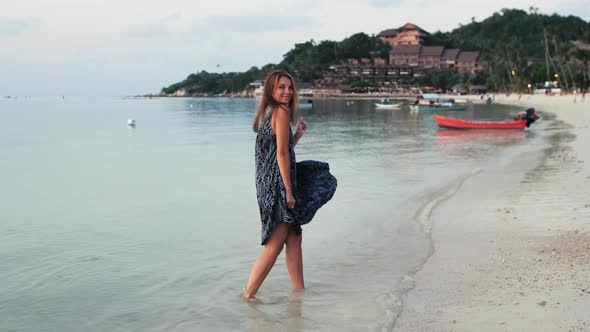 Young Woman Dancing Enjoying Spinning Around Vacation Travel on Tropical Beach