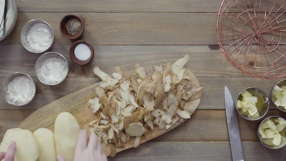 Flat lay. Peeling organic yellow potatoes with potato peeler