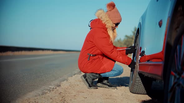 Woman Check Car Tire Pressure. Vehicle Trouble On Road On Vacation Trip. Female Trying Fix Car Tire.