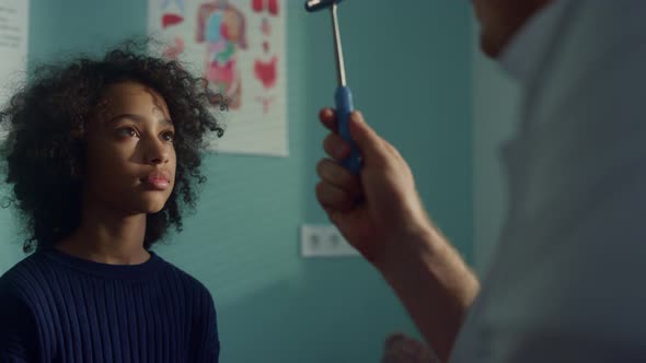 Neurologist Checking Visual Reflex African American Teen Kid in Modern Clinic