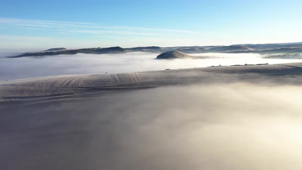 Flying Over Hills in mystic Foggy Winter Morning