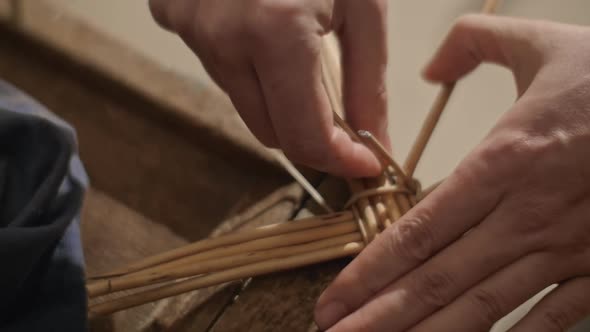 Closeup of Hands Weaving a Basket From Willow Branches