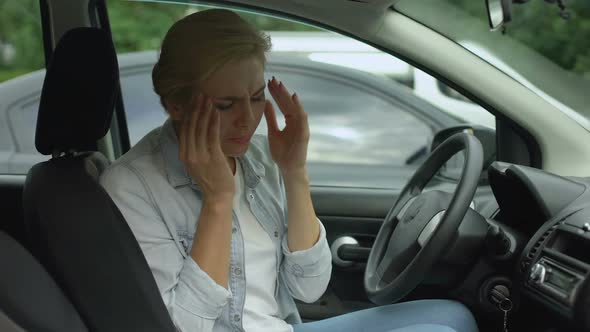 Blond Female Suffering From Strong Migraine, Sitting in Auto, Headache Disorder