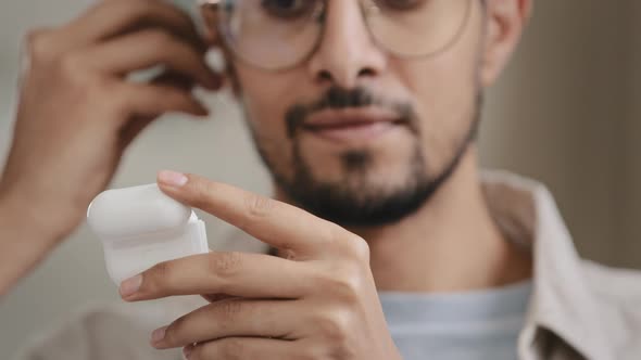 Closeup Male Face Bearded Arab Spaniard Man Guy with Glasses Opens Box with Headphones Inserts