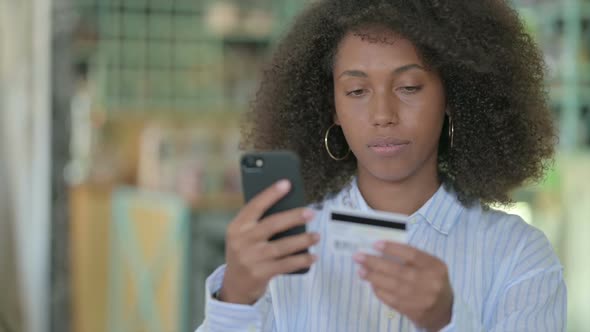 Portrait of African Businesswoman Making Successful Online Payment on Smartphone