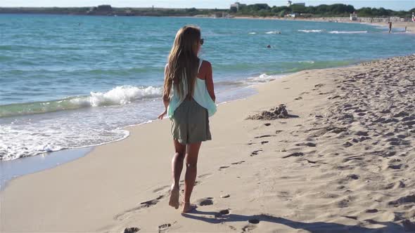 Adorable Active Little Girl at Beach During Summer Vacation