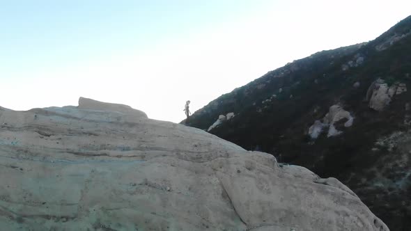Woman walks on mountain ridge