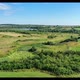 Aerial view of countryside scenic landscape, push in. Cows graze in the green meadow - VideoHive Item for Sale