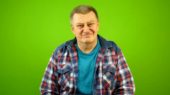 Confused Puzzled Bewildered Senior Caucasian Man in Checkered Shirt Shrugging Shoulders