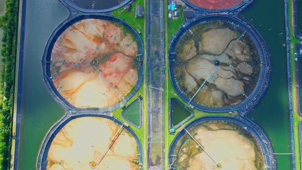 An aerial view of a drone flying over a large shrimp farm