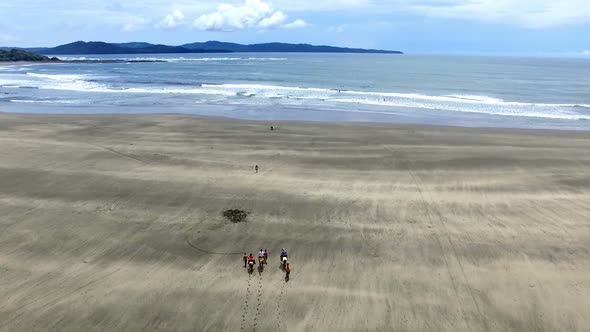 Family Riding Horses on the Seashore