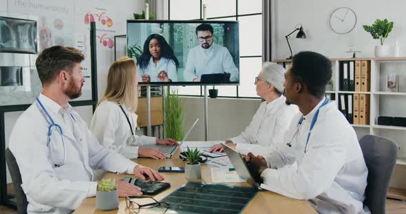 Multiethnic Doctors which are Satisfied Effective Online Meeting with Male Head Doctor