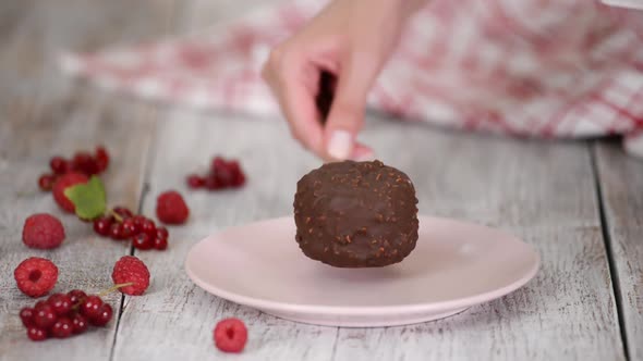 Putting Chocolate Ice Cream on a Pink Plate