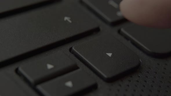 Finger Presses the Right Button on the Keyboard