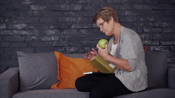 Woman Spending Time at Home and Reading Her Favorite Book