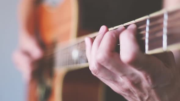 Crop man playing guitar