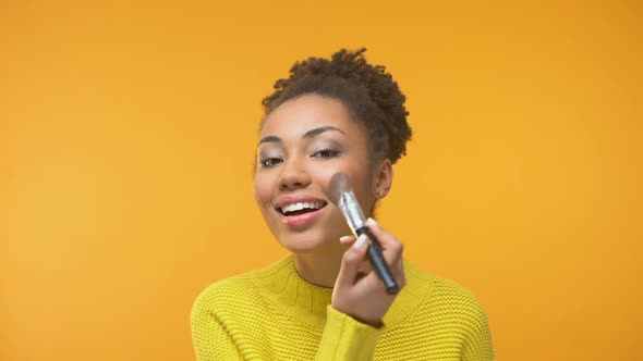 Happy Black Woman Applying Blush, Young Lady Preparing for Date, Close-Up