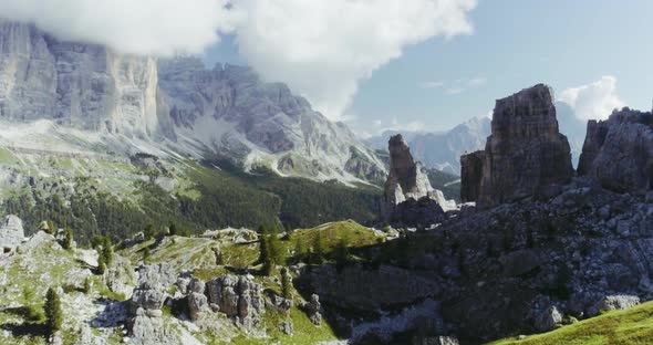 Aerial Flight Above Mountain Top with Pines and Rocks in Sunny Day