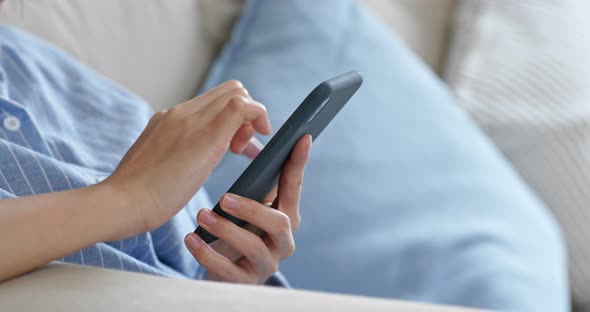 Woman use of mobile phone at home