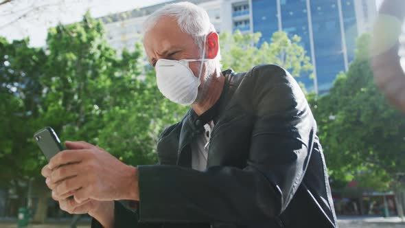 Caucasian man out and about in the street wearing on a face mask against coronavirus