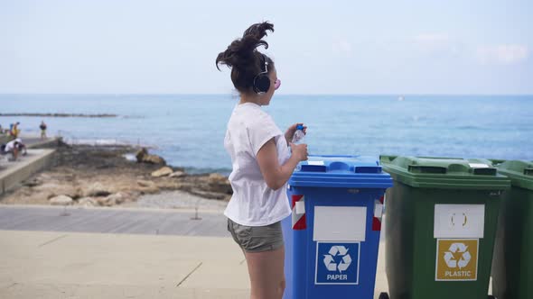 Slim Young Sportswoman Running on Coast Beach Throwing Empty Water Bottle on Plastic Waste Bin and