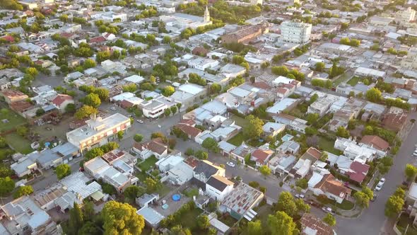 Aerial Drone shot tilting up of a little town during sunset, in Coronel Dorrego, Argentina