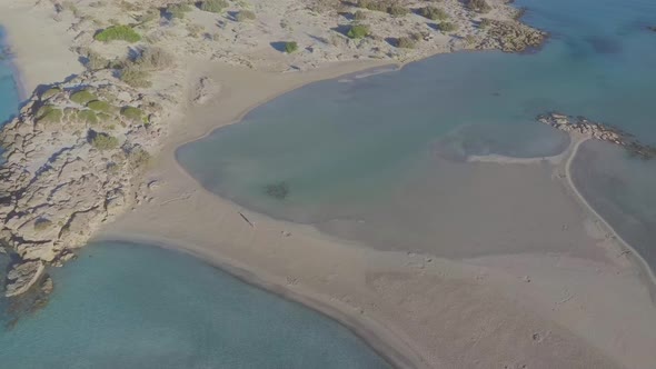 Aerial view of a walking woman on a idyllic paradise beach. Long shot