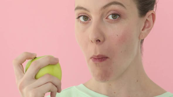 Young Woman is Eating an Apple Healthy Nutrition