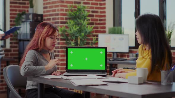 Business People Looking at Laptop with Green Screen