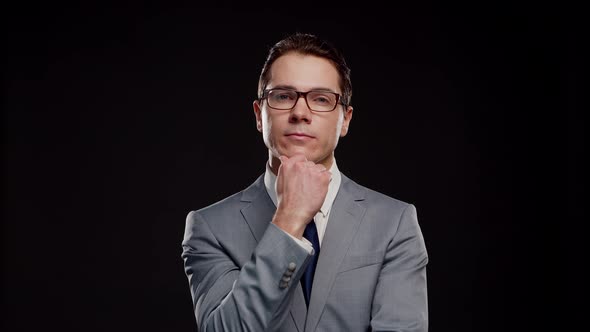 Studio portrait of successful and smart businessman in suit and tie.