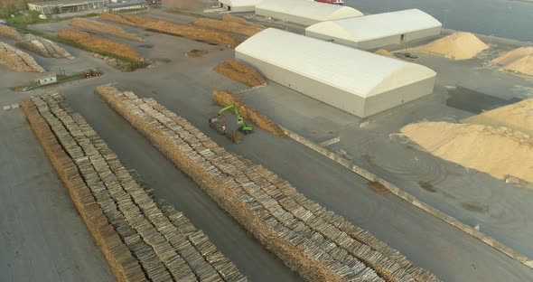 Tree Logs in Timber Terminal Port Crane Unloading Logging Truck Aerial View