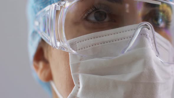 Female Doctor or Nurse in Goggles and Face Mask