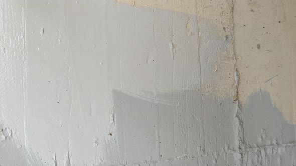 Painting a Concrete Wall with a Brush Close Up